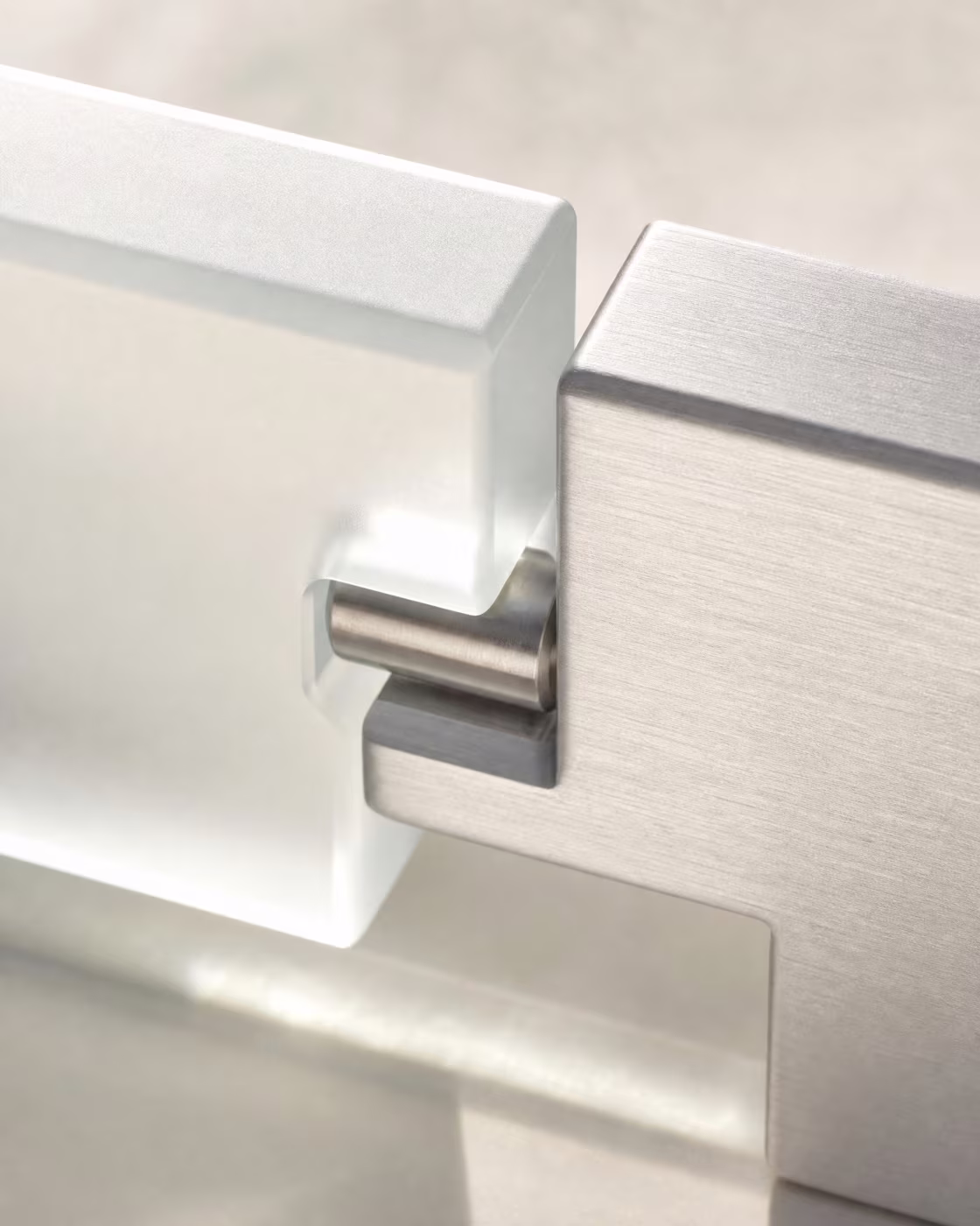 Close-up of a frosted glass and brushed metal joint